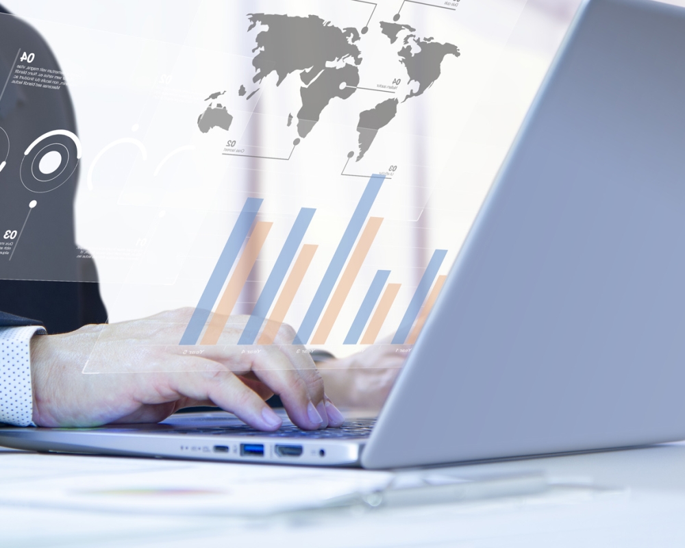 Businessman or analyst with concentration typing on laptop computer notebook for financial reports analysis and return on investment, ROI, or investment risk. Side copy space included.